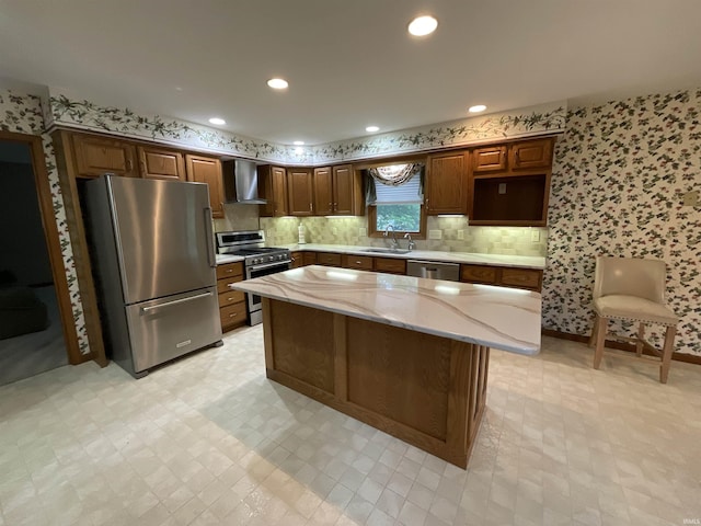 404 Ridge Ct, Ossian, IN 46777 - kitchen featuring appliances with stainless steel finishes, wall chimney exhaust hood, wallpapered walls, a sink, and a kitchen island