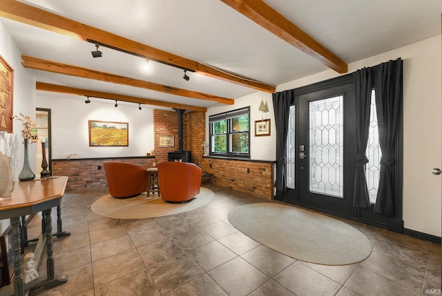 2905 E Mowrey Rd, Columbia City, IN 46725 - entrance foyer featuring brick wall, a wood stove, track lighting, and beam ceiling
