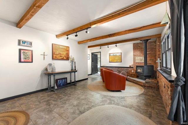 2905 E Mowrey Rd, Columbia City, IN 46725 - living area with beamed ceiling, track lighting, a wood stove, and baseboards