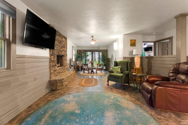 2905 E Mowrey Rd, Columbia City, IN 46725 - living room featuring a fireplace, a textured ceiling, and ceiling fan