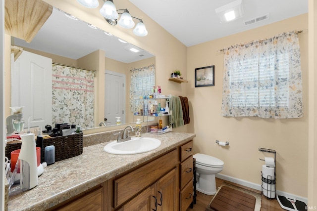 2082 Hemlock Ln, Warsaw, IN 46580 - full bathroom with vanity, toilet, and baseboards