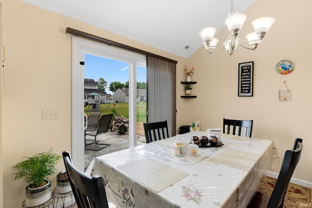 2082 Hemlock Ln, Warsaw, IN 46580 - carpeted dining space with a chandelier, vaulted ceiling, and baseboards