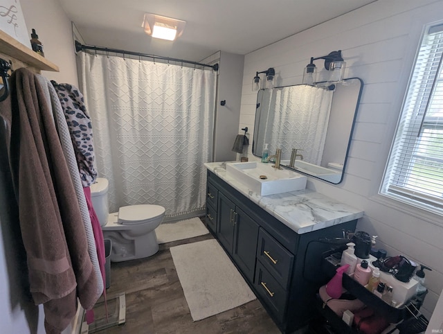 664 Columbia St, Berne, IN 46711 - bathroom featuring toilet, wood finished floors, vanity, and a shower with shower curtain