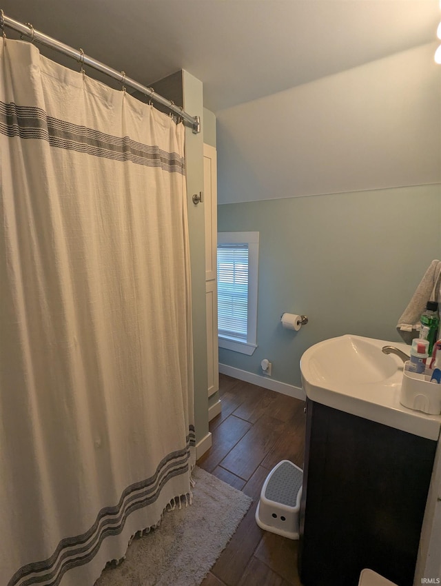 664 Columbia St, Berne, IN 46711 - bathroom featuring wood finished floors, vanity, baseboards, and a shower with curtain
