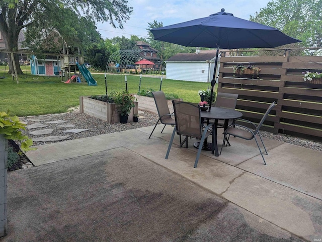664 Columbia St, Berne, IN 46711 - view of patio featuring outdoor dining area and a playground