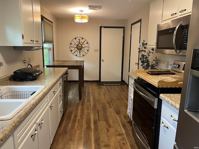 7140 Karen Ct, Fort Wayne, IN 46835 - kitchen with stainless steel appliances, dark wood-type flooring, white cabinets, light countertops, and a sink