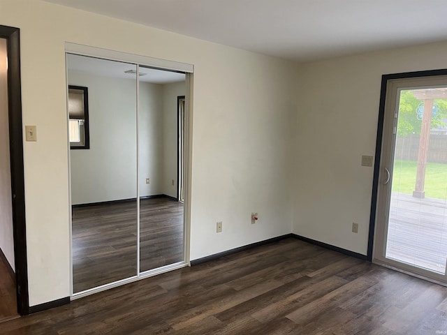 7140 Karen Ct, Fort Wayne, IN 46835 - unfurnished bedroom featuring dark wood finished floors, access to exterior, baseboards, and a closet