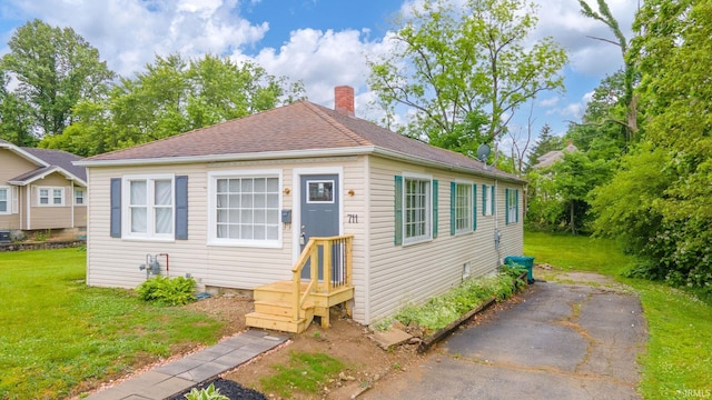 711 S 15th St, New Castle, IN 47362 - shotgun-style home featuring a front yard and a chimney