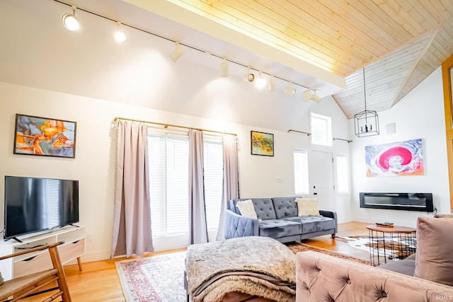 2910 W Devon Rd, Muncie, IN 47304 - living area featuring rail lighting, lofted ceiling, light wood-type flooring, baseboards, and a chandelier