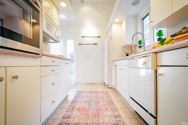 2910 W Devon Rd, Muncie, IN 47304 - kitchen featuring white appliances, light tile patterned floors, light countertops, recessed lighting, and white cabinets
