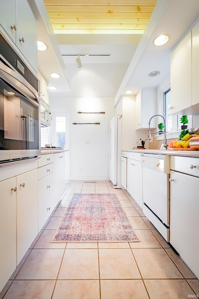 2910 W Devon Rd, Muncie, IN 47304 - kitchen featuring white appliances, healthy amount of natural light, light tile patterned floors, light countertops, and recessed lighting