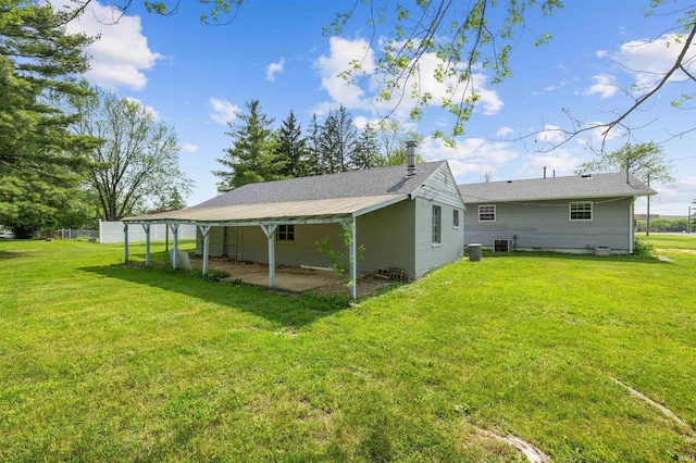 9129 Winchester Rd, Fort Wayne, IN 46819 - back of property featuring a yard and central AC