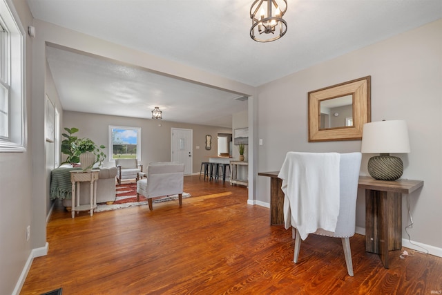 9129 Winchester Rd, Fort Wayne, IN 46819 - interior space featuring wood finished floors, baseboards, and a chandelier