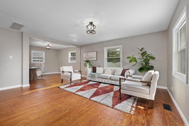 9129 Winchester Rd, Fort Wayne, IN 46819 - living room featuring wood finished floors, a chandelier, and baseboards