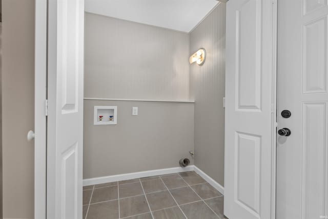 9129 Winchester Rd, Fort Wayne, IN 46819 - laundry area with hookup for a washing machine, dark tile patterned floors, and baseboards