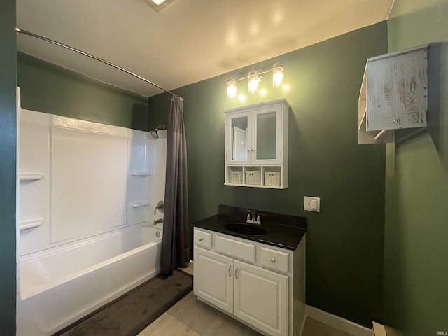 304 E 26th St, Muncie, IN 47302 - bathroom featuring vanity, shower / tub combo with curtain, and wood finished floors