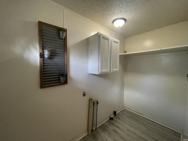304 E 26th St, Muncie, IN 47302 - laundry room featuring a textured ceiling, light wood finished floors, baseboards, and ornamental molding