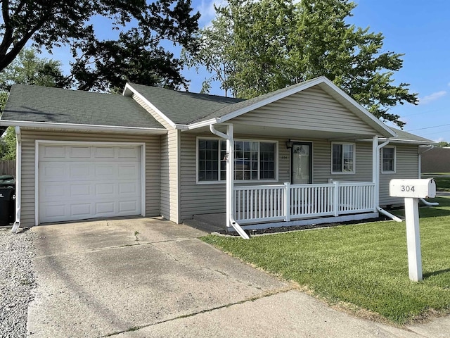 304 E 26th St, Muncie, IN 47302 - ranch-style home featuring a porch, an attached garage, a front lawn, driveway, and a shingled roof