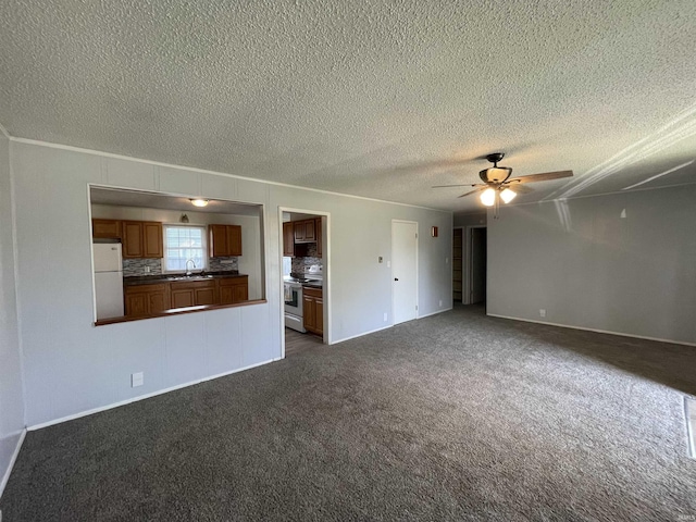 304 E 26th St, Muncie, IN 47302 - unfurnished living room with a sink, ceiling fan, dark carpet, a textured ceiling, and ornamental molding