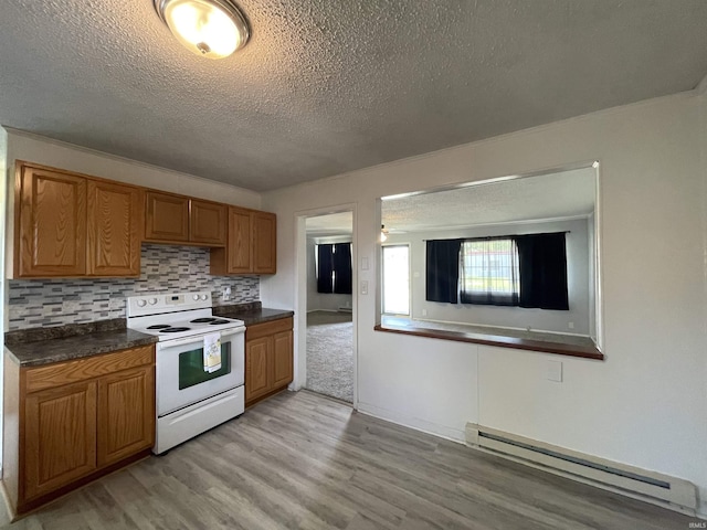 304 E 26th St, Muncie, IN 47302 - kitchen with electric stove, baseboard heating, a textured ceiling, light wood-style flooring, and dark countertops