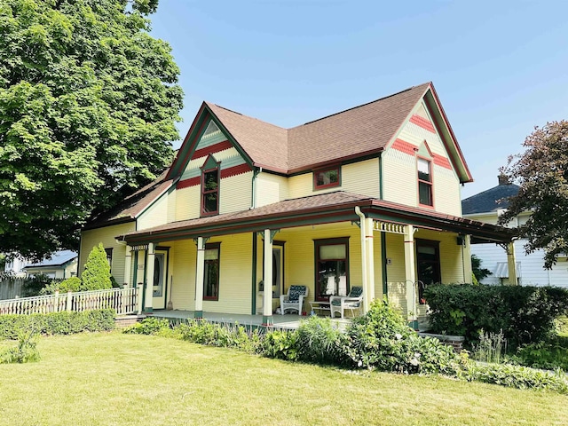 201 N Lafayette St, North Liberty, IN 46554 - victorian home featuring a front lawn, covered porch, and roof with shingles