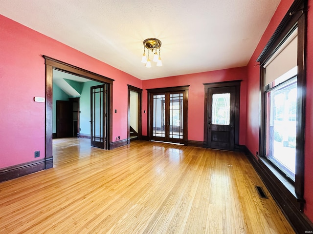 201 N Lafayette St, North Liberty, IN 46554 - empty room with a chandelier, light wood-style flooring, and baseboards