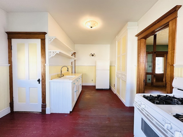 201 N Lafayette St, North Liberty, IN 46554 - laundry room with a wainscoted wall, a sink, and dark wood-type flooring
