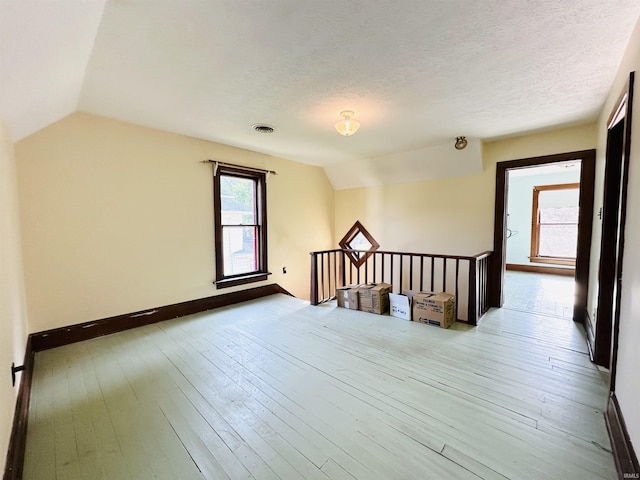 201 N Lafayette St, North Liberty, IN 46554 - bonus room with vaulted ceiling, hardwood / wood-style flooring, a textured ceiling, and baseboards
