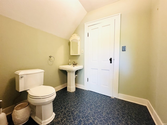201 N Lafayette St, North Liberty, IN 46554 - bathroom with toilet, vaulted ceiling, baseboards, and a sink