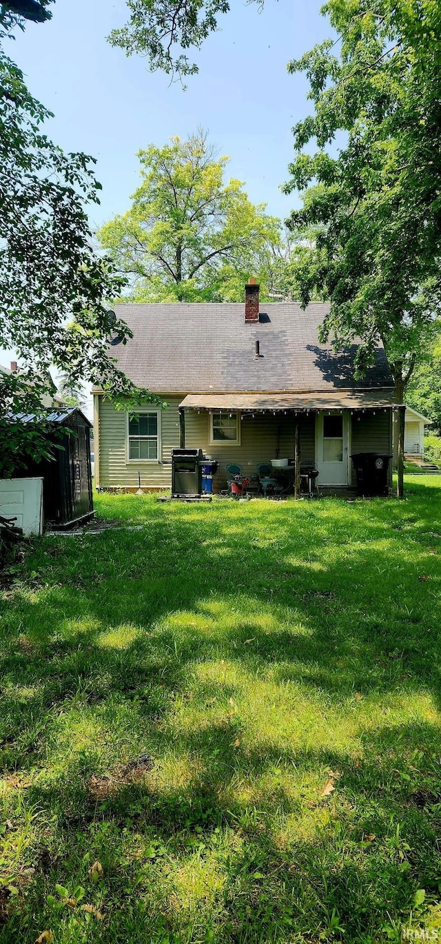 3213 Robinwood Dr, Fort Wayne, IN 46806 - back of house with a lawn and a chimney