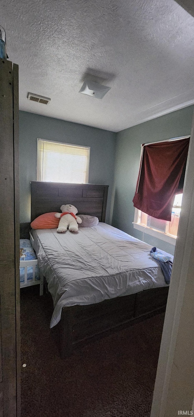 3213 Robinwood Dr, Fort Wayne, IN 46806 - carpeted bedroom with a textured ceiling