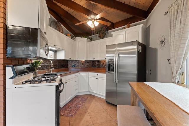 61560 Druid Ln, South Bend, IN 46614 - kitchen featuring appliances with stainless steel finishes, wooden ceiling, a sink, decorative backsplash, and light tile patterned flooring