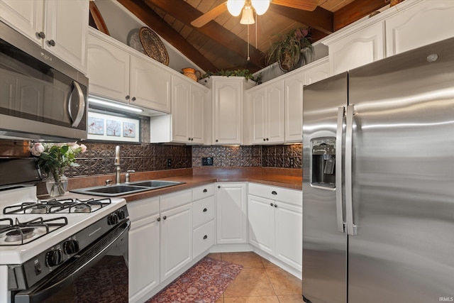 61560 Druid Ln, South Bend, IN 46614 - kitchen featuring appliances with stainless steel finishes, a sink, wood ceiling, decorative backsplash, and light tile patterned floors