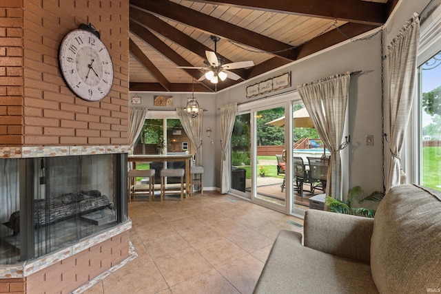 61560 Druid Ln, South Bend, IN 46614 - living room with wooden ceiling, tile patterned flooring, healthy amount of natural light, ceiling fan, and a fireplace