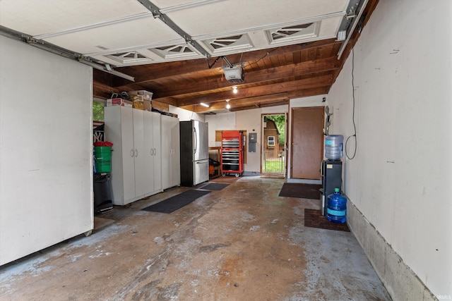 61560 Druid Ln, South Bend, IN 46614 - garage featuring freestanding refrigerator and a garage door opener