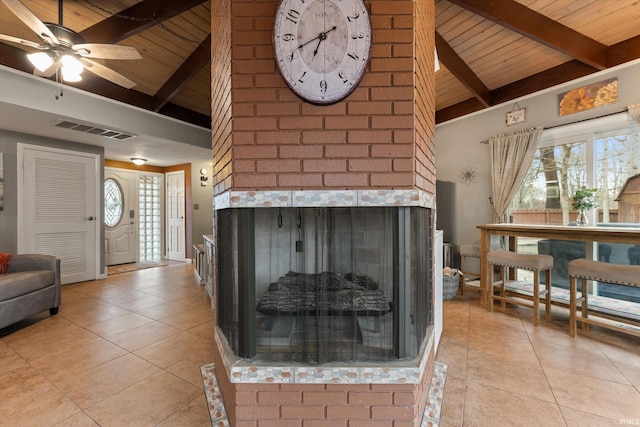 61560 Druid Ln, South Bend, IN 46614 - living room featuring a fireplace, wood ceiling with exposed beams, light tile patterned floors, high vaulted ceiling, and healthy amount of natural light