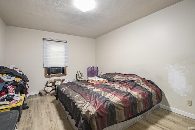 3311 Ardmore Trl, South Bend, IN 46628 - bedroom featuring wood finished floors, cooling unit, and baseboards