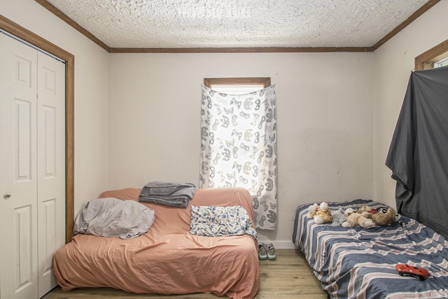 3311 Ardmore Trl, South Bend, IN 46628 - bedroom with wood finished floors, a textured ceiling, ornamental molding, and a closet