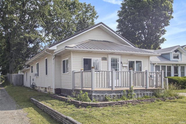 3311 Ardmore Trl, South Bend, IN 46628 - view of front of home with a wooden deck, a front yard, and cooling unit