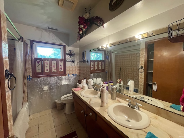 520 S Butterfield Rd, Muncie, IN 47302 - full bathroom featuring tile patterned floors, double vanity, toilet, wallpapered walls, and wainscoting