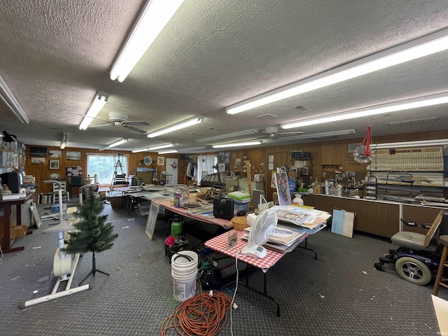 520 S Butterfield Rd, Muncie, IN 47302 - garage featuring a ceiling fan, a workshop area, and wooden walls