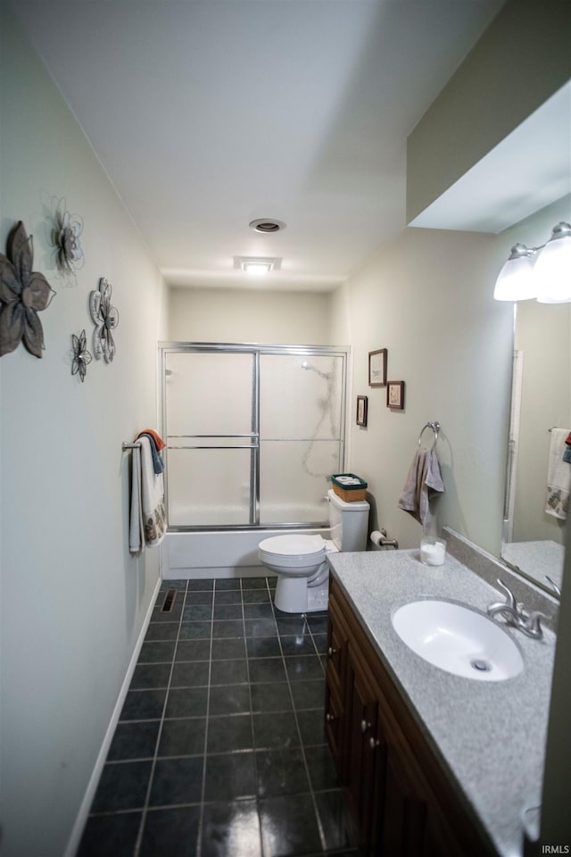5101 Weir Dr, Muncie, IN 47304 - bathroom with toilet, vanity, combined bath / shower with glass door, and tile patterned floors
