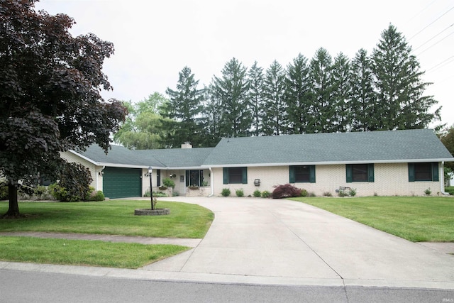5101 Weir Dr, Muncie, IN 47304 - ranch-style home featuring concrete driveway, an attached garage, a chimney, and a front yard