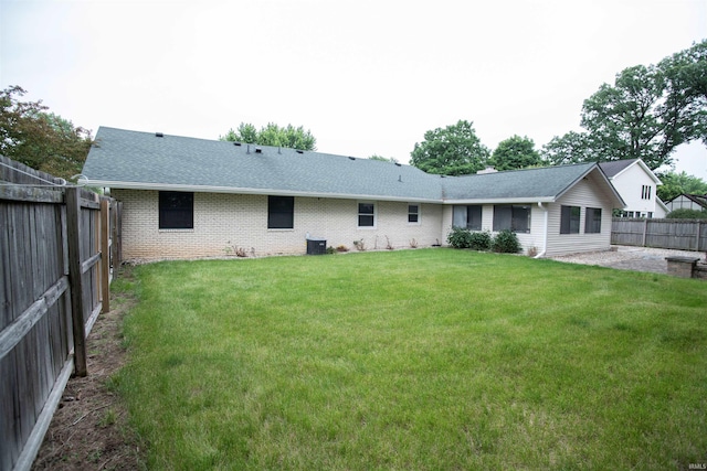 5101 Weir Dr, Muncie, IN 47304 - rear view of house with brick siding, roof with shingles, and central AC