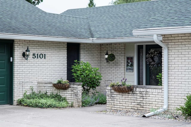 5101 Weir Dr, Muncie, IN 47304 - doorway to property with brick siding and a shingled roof