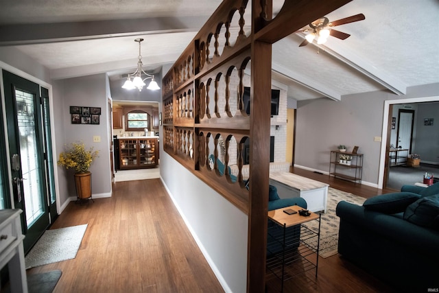 5101 Weir Dr, Muncie, IN 47304 - hall with beam ceiling, wood finished floors, baseboards, and a chandelier