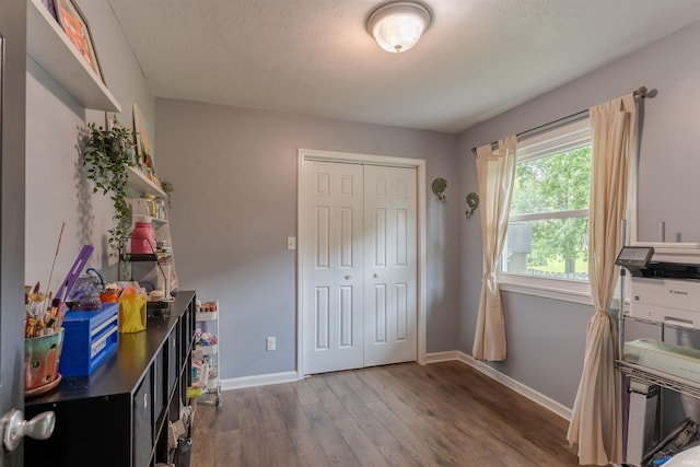 863 S Melchior Dr, Santa Claus, IN 47579 - bedroom featuring wood finished floors, a closet, baseboards, and a textured ceiling