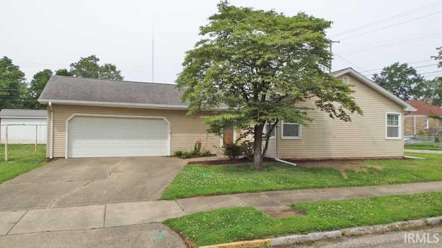 1001 Barnett St, Vincennes, IN 47591 - view of front of house featuring a front yard, a garage, and driveway