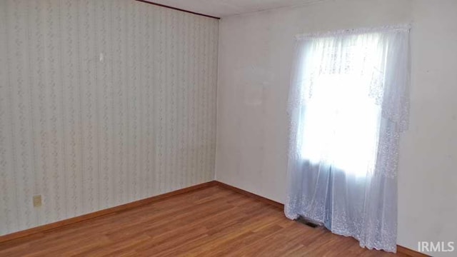 1001 Barnett St, Vincennes, IN 47591 - spare room featuring wood finished floors and baseboards