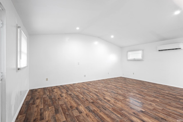415 N Washington St, Warsaw, IN 46580 - unfurnished room featuring a wall mounted AC, recessed lighting, vaulted ceiling, dark wood finished floors, and baseboards